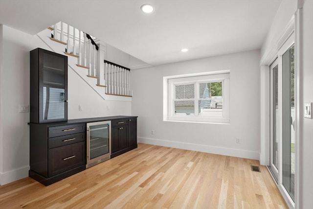 14 Norman Ave, Newburyport, MA 01950 - indoor dry bar featuring beverage cooler, light wood finished floors, recessed lighting, and stairs