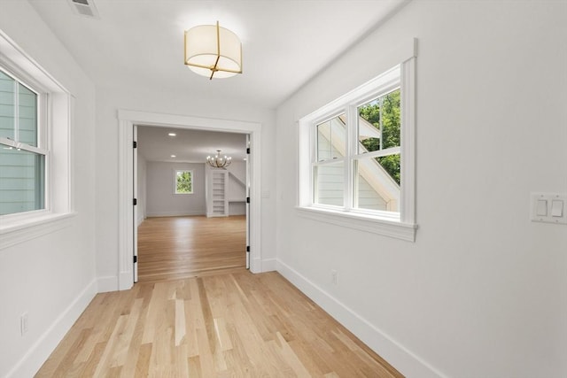 14 Norman Ave, Newburyport, MA 01950 - corridor with light wood finished floors and a chandelier