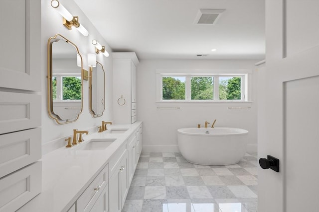 14 Norman Ave, Newburyport, MA 01950 - full bath featuring healthy amount of natural light, double vanity, a freestanding tub, and recessed lighting