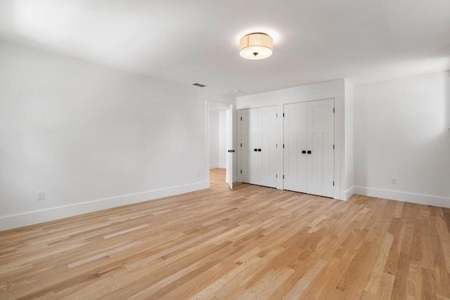 14 Norman Ave, Newburyport, MA 01950 - unfurnished bedroom featuring multiple closets and light wood-style flooring