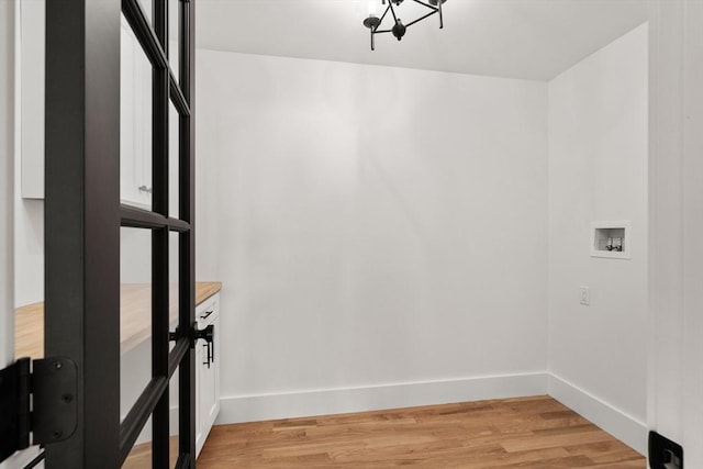 14 Norman Ave, Newburyport, MA 01950 - laundry room featuring washer hookup, a chandelier, and light wood-style flooring