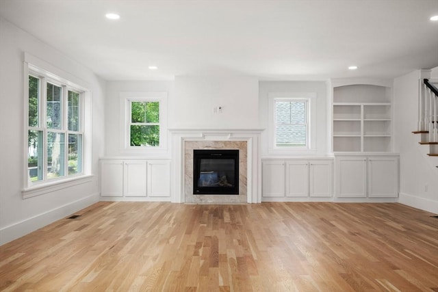 14 Norman Ave, Newburyport, MA 01950 - unfurnished living room with stairs, a fireplace, wood finished floors, recessed lighting, and built in features