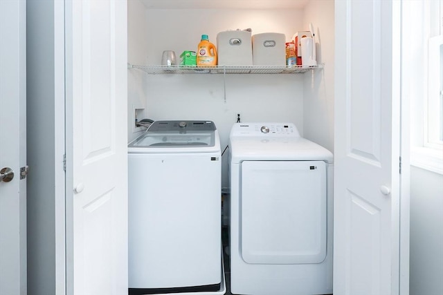 clothes washing area with laundry area and separate washer and dryer