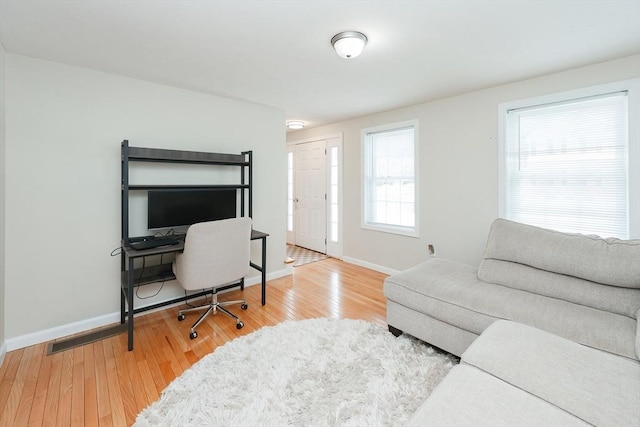 office space with wood finished floors and baseboards