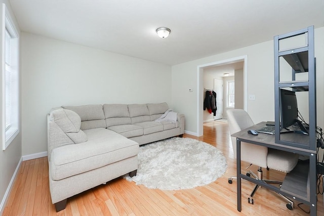 living room featuring baseboards and wood finished floors