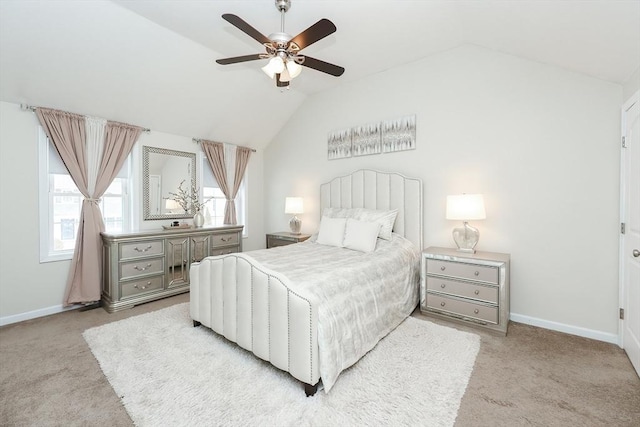 bedroom with baseboards, vaulted ceiling, and light colored carpet