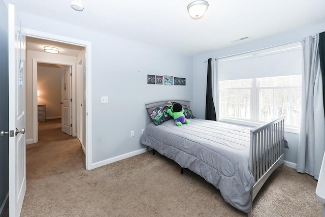 bedroom with light carpet and baseboards