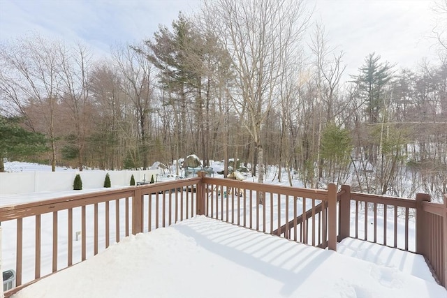 snow covered deck featuring fence