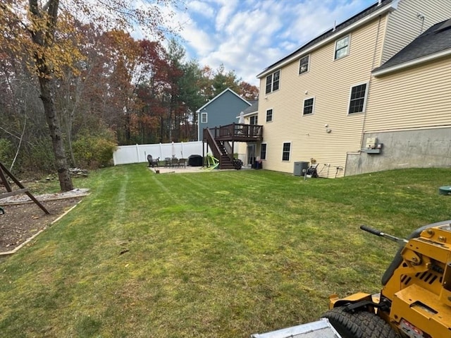 view of yard featuring a deck, fence, stairway, and a patio