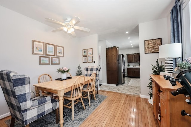 dining area featuring ceiling fan, light wood finished floors, recessed lighting, and baseboards