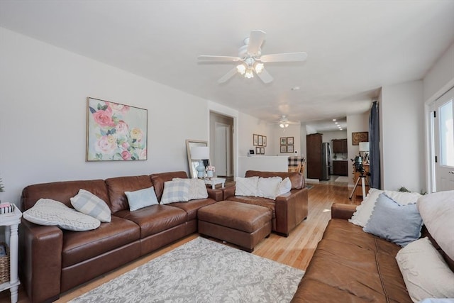 living room featuring ceiling fan and light wood-style flooring