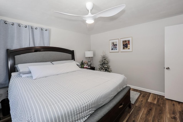 bedroom featuring wood finished floors, a ceiling fan, and baseboards