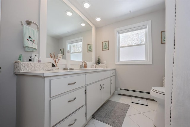 bathroom featuring recessed lighting, toilet, a baseboard heating unit, vanity, and tile patterned floors