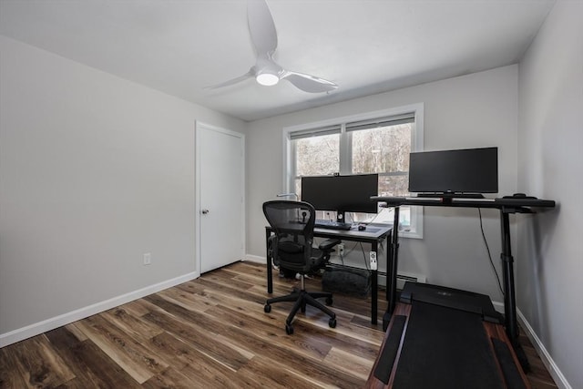 office space featuring wood finished floors, a ceiling fan, and baseboards