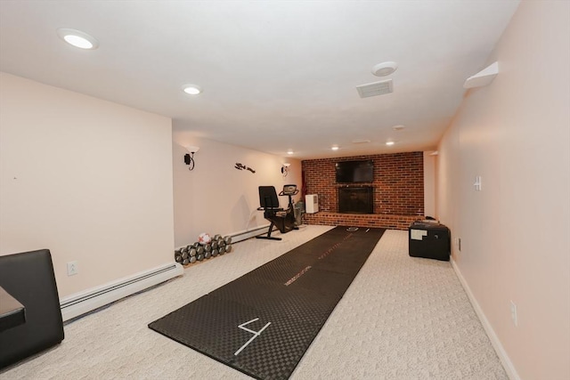 exercise area featuring baseboards, a baseboard radiator, baseboard heating, carpet floors, and a brick fireplace