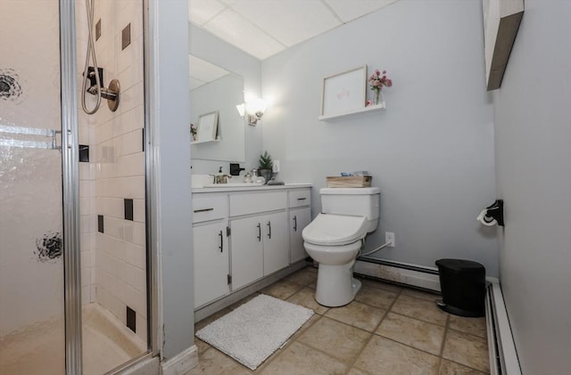 bathroom with a baseboard heating unit, a stall shower, vanity, and toilet