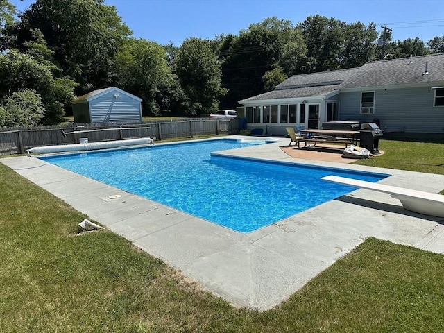 view of pool featuring fence, a sunroom, a lawn, a fenced in pool, and a patio area