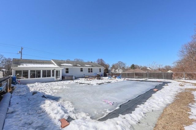 snow covered property featuring a fenced backyard