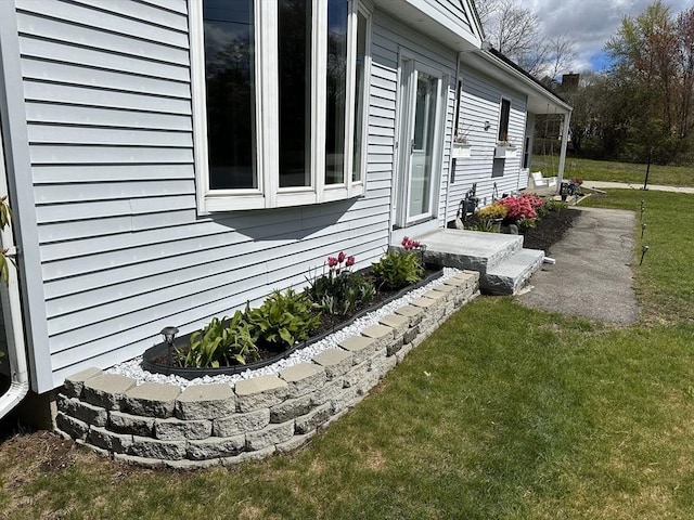 view of property exterior with a lawn