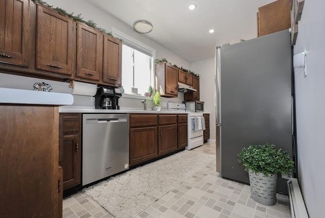 kitchen with a baseboard radiator, recessed lighting, light countertops, appliances with stainless steel finishes, and under cabinet range hood