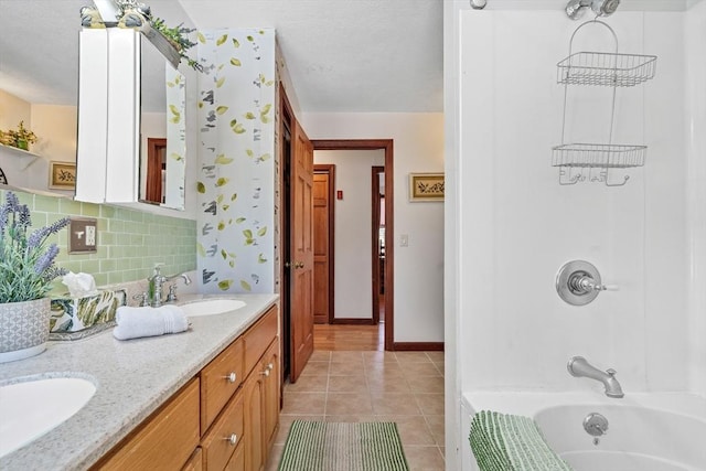 bathroom featuring a sink, backsplash, shower / bathtub combination, and tile patterned flooring