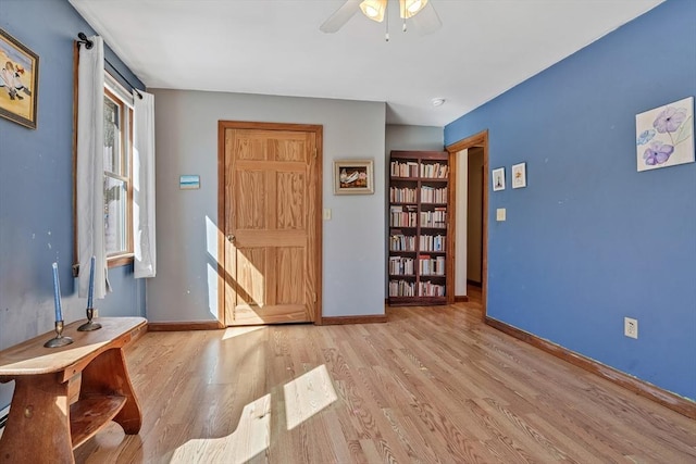 entrance foyer featuring wood finished floors, baseboards, and ceiling fan