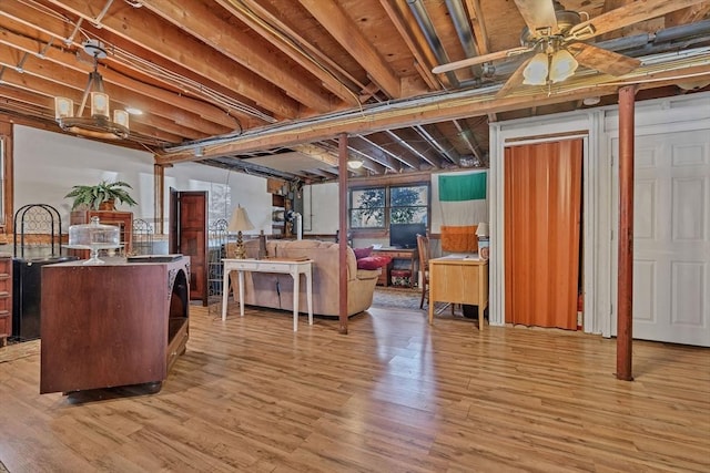 basement with light wood-type flooring and ceiling fan