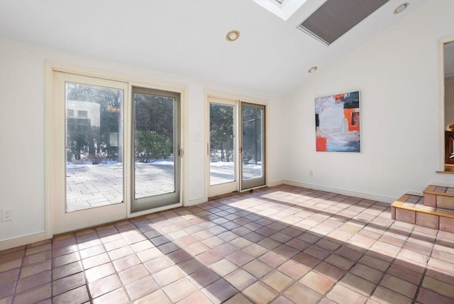 doorway to outside with vaulted ceiling with skylight and light tile patterned floors