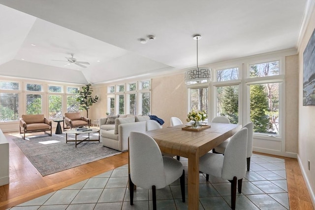 dining room with lofted ceiling, crown molding, light hardwood / wood-style flooring, and ceiling fan