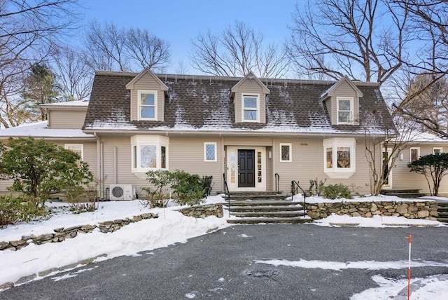 cape cod house featuring ac unit