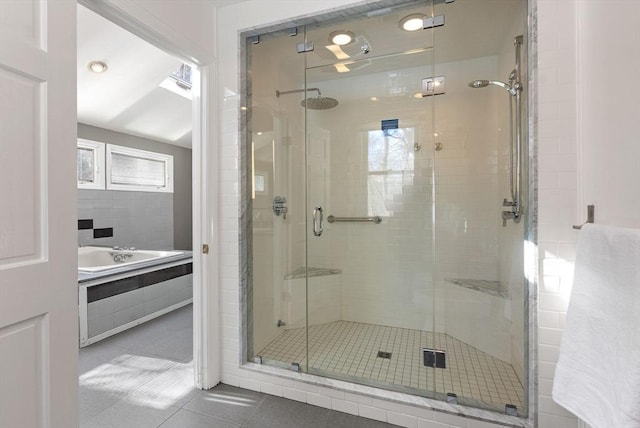 bathroom featuring plus walk in shower and tile patterned flooring