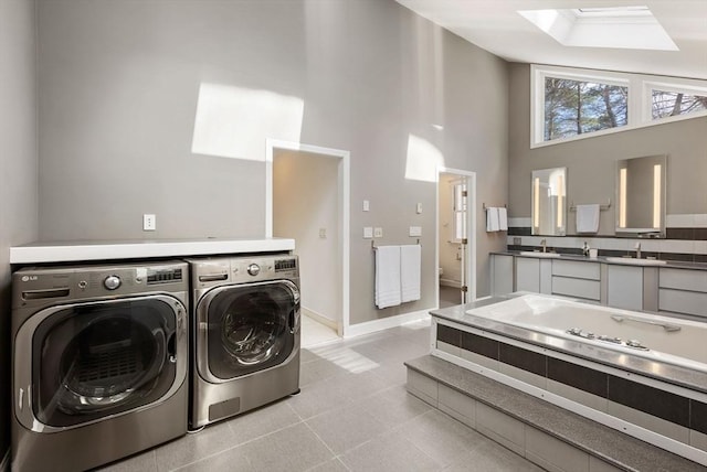 laundry area featuring a towering ceiling and separate washer and dryer