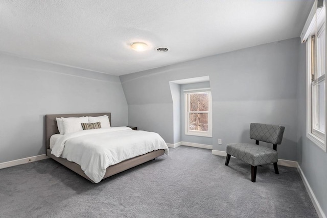 carpeted bedroom featuring a textured ceiling