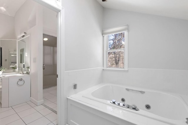 bathroom featuring lofted ceiling, tile patterned floors, shower with separate bathtub, and vanity