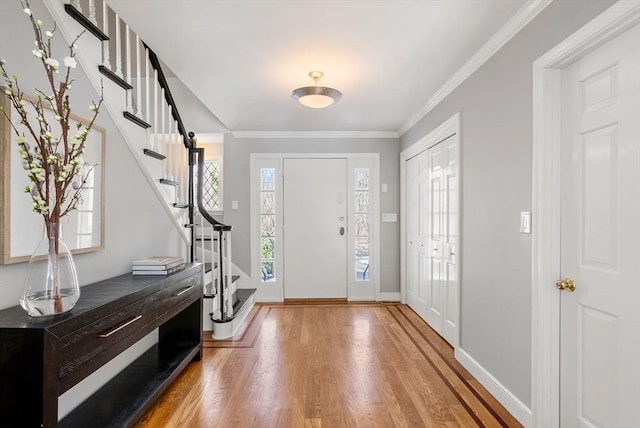 foyer featuring hardwood / wood-style flooring and crown molding