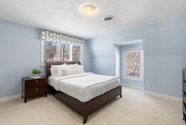 bedroom featuring multiple windows and light colored carpet