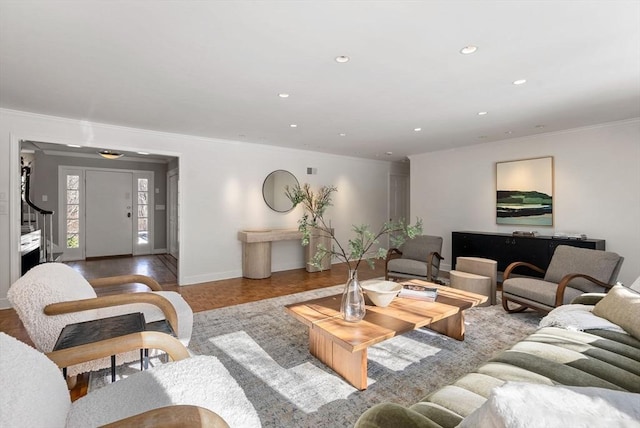 living room with crown molding and light parquet flooring