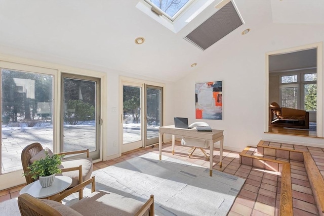 office featuring vaulted ceiling with skylight and light tile patterned floors