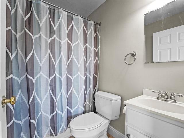full bath featuring toilet, a shower with shower curtain, and vanity