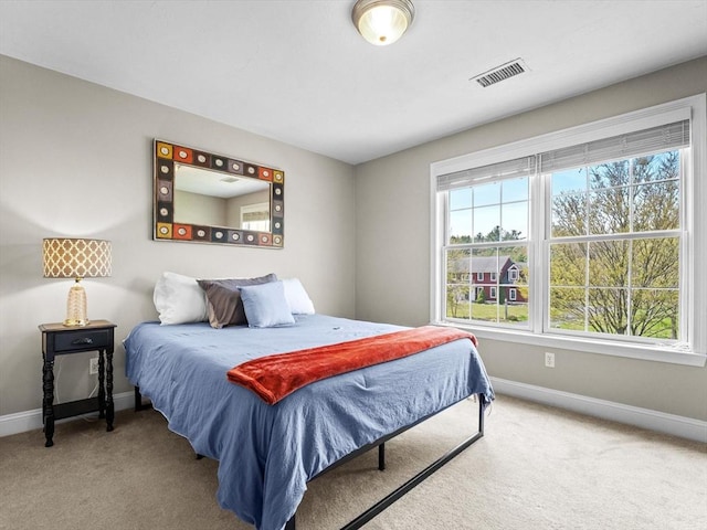 carpeted bedroom with baseboards and visible vents