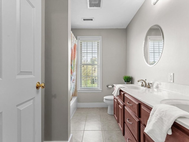 bathroom featuring visible vents, double vanity, baseboards, and toilet