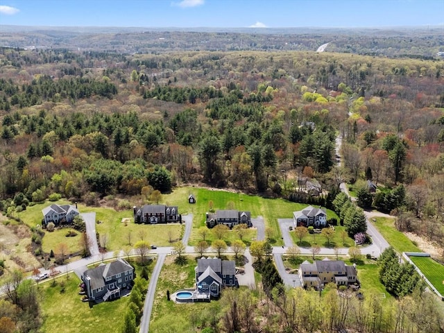 birds eye view of property featuring a wooded view