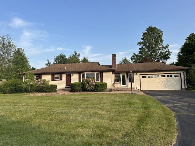 985 Tinkham Rd, Wilbraham, MA 01095 - single story home with a garage, driveway, a chimney, and a front lawn