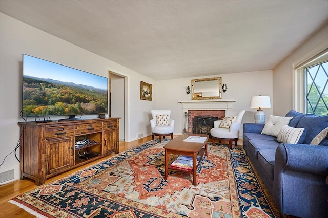 985 Tinkham Rd, Wilbraham, MA 01095 - living area featuring wood finished floors and a brick fireplace