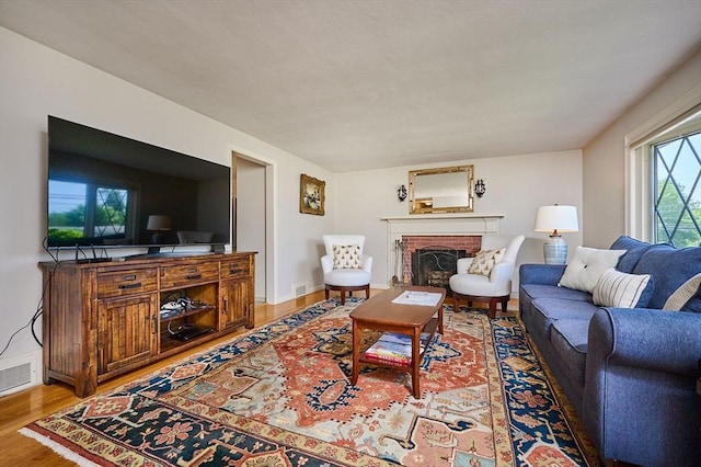 985 Tinkham Rd, Wilbraham, MA 01095 - living room featuring wood finished floors and a brick fireplace