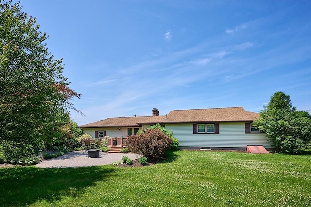 985 Tinkham Rd, Wilbraham, MA 01095 - rear view of house featuring a patio area, a lawn, a chimney, and an outdoor fire pit