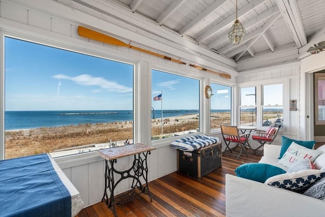 sunroom / solarium with a view of the beach, vaulted ceiling with beams, a water view, and wooden ceiling