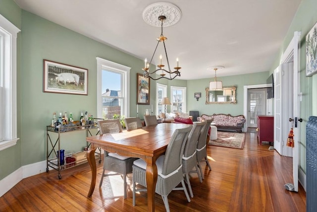 dining area featuring a chandelier and hardwood / wood-style flooring