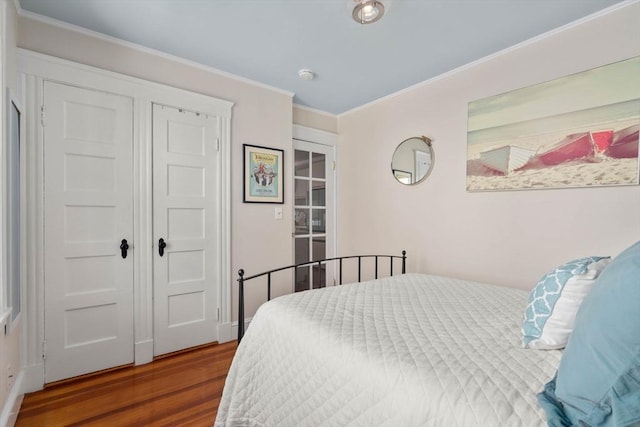 bedroom featuring hardwood / wood-style flooring and crown molding