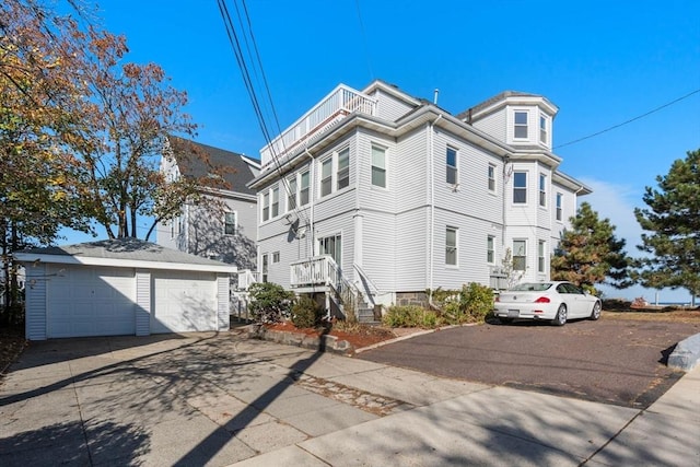 view of front of home with a garage and an outdoor structure